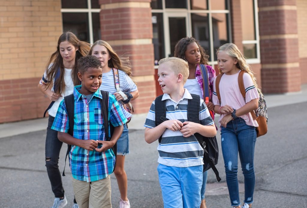A group of elementary school kids leave a school building in Bend, Oregon. 